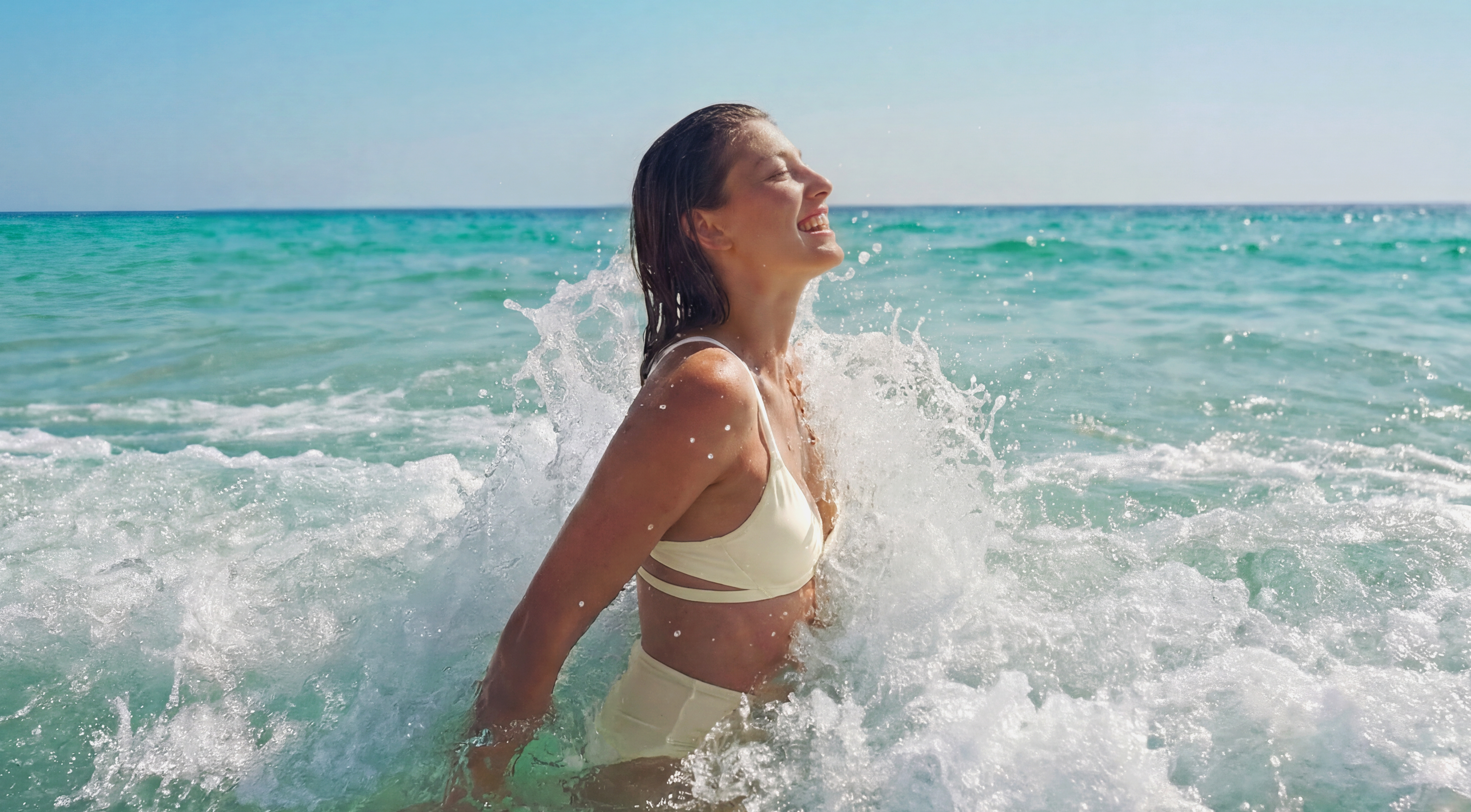 Woman surfing in Kestos sportswear, demonstrating land-to-water versatility